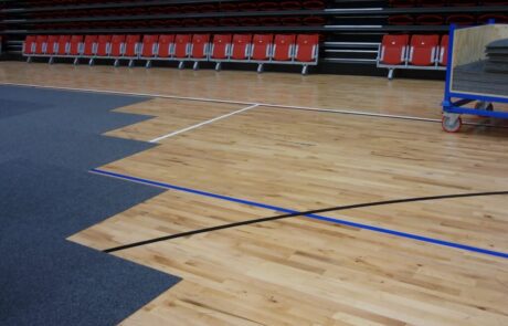 Carpet tiles over a sports floor